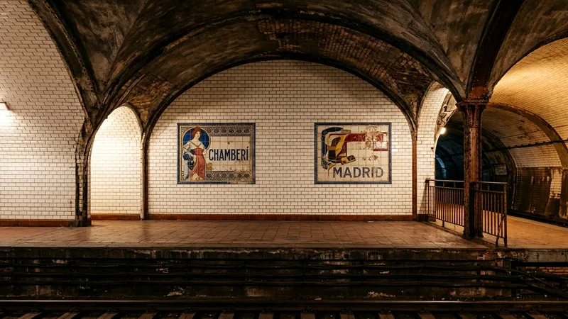 Vintage tiled Madrid Metro platform with curved vault and ceramic panels